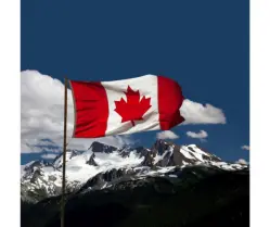 Canadian Flag with mountains in the background